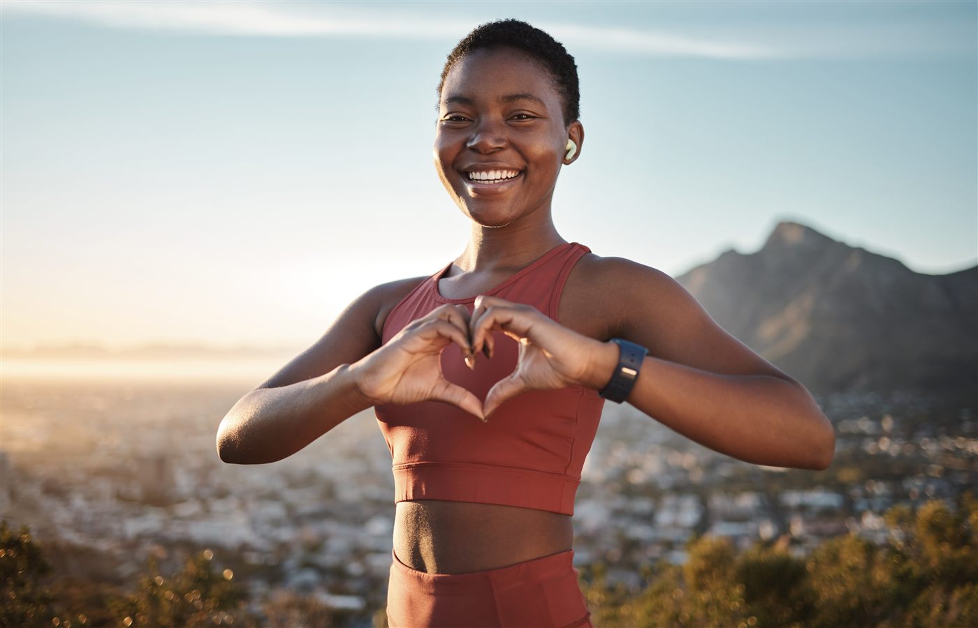 Person forming a heart shape with their hands
